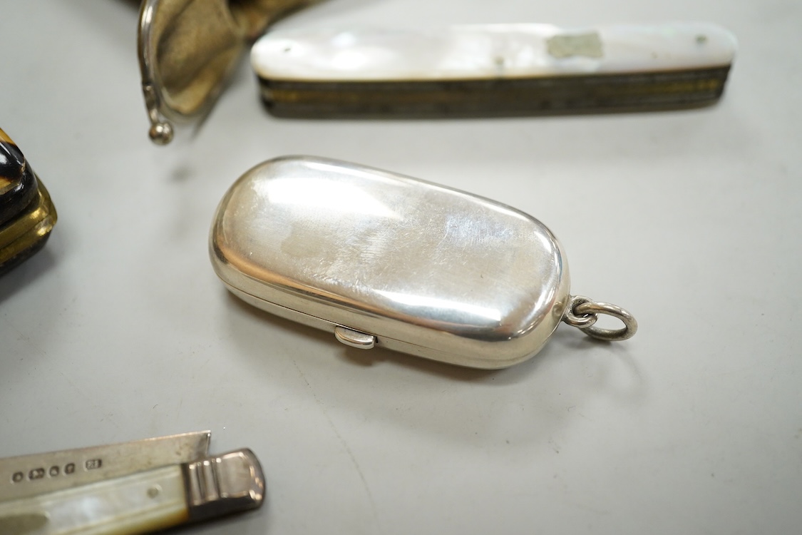 A George V engine turned silver mounted rectangular cigarette box, Birmingham, 1923, 17.7cm, a sterling mounted pepper grinder, four weighted sterling condiments and a small plated tray.